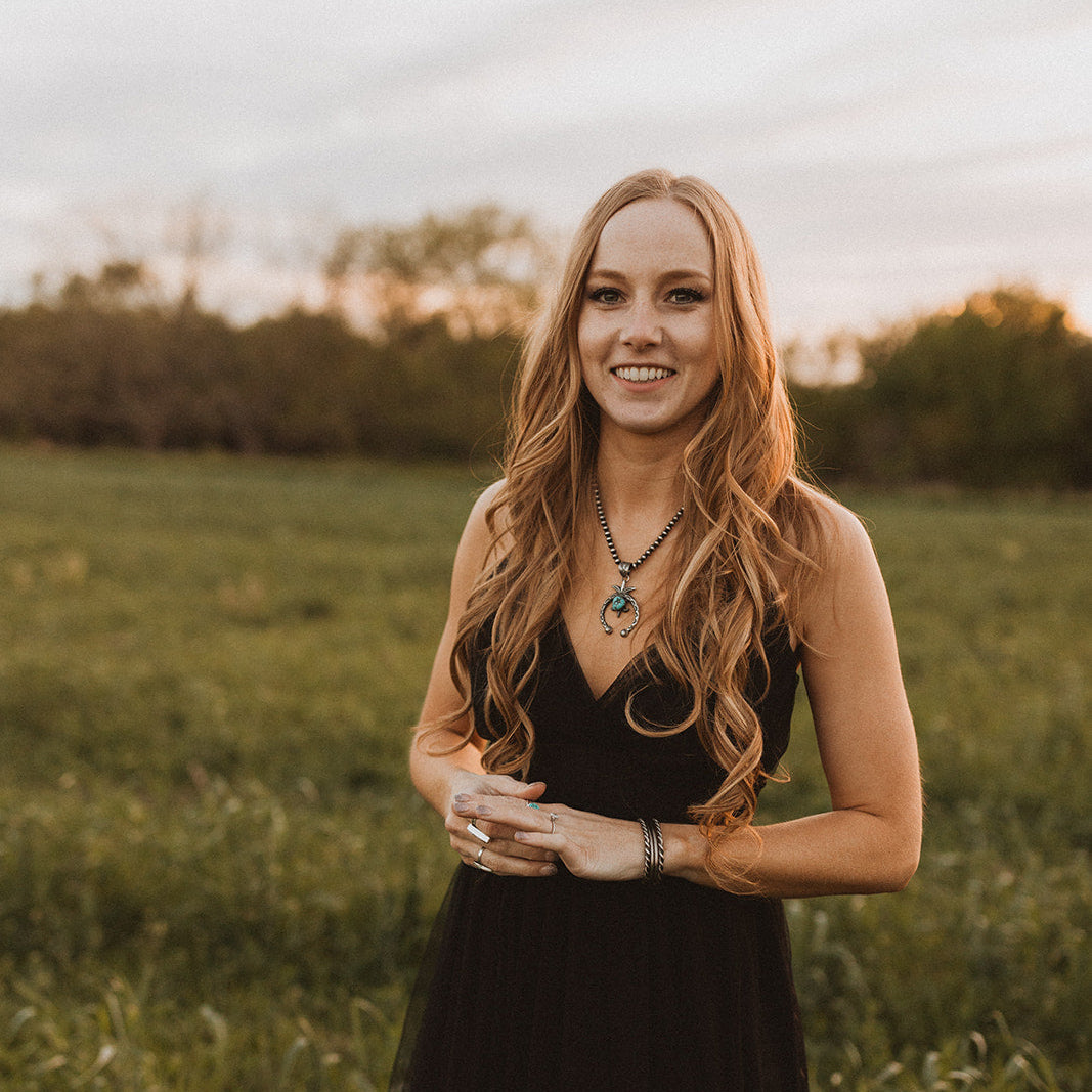 a woman smiling in a black dress 